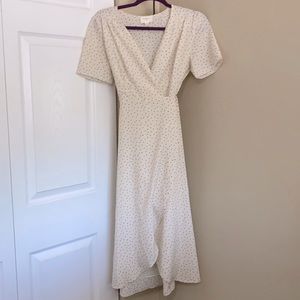 Cream wrap dress with black pattern.